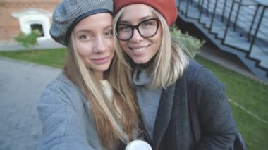 Arkadaşlık ve ilişki kavramı. İki genç kadın kendi portresini çekiyor.