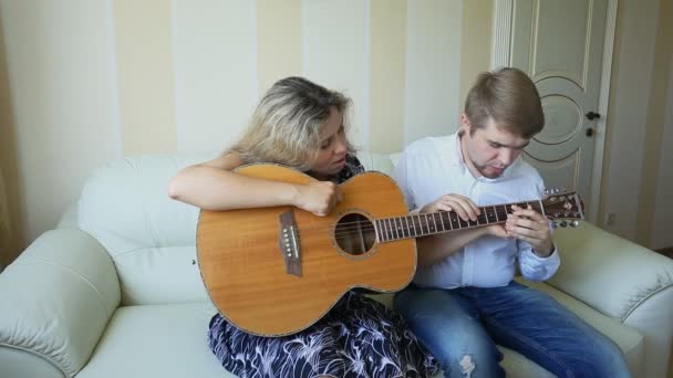 Música, venda, pessoas, instrumentos musicais e conceito de entretenimento - casal feliz de músicos com guitarra — Vídeo de Stock