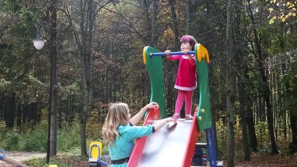 Mother and daughter walking in the park autumn — Stock Video