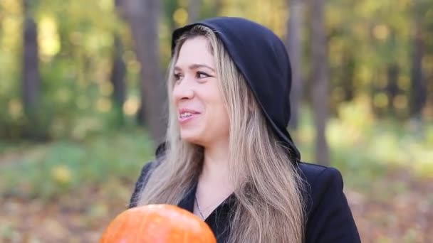 Beautiful witch with a pumpkin — Stock Video
