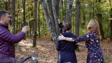 Mutlu genç ailesi selfies onun smartphone ile parkta alarak sonbahar sahne