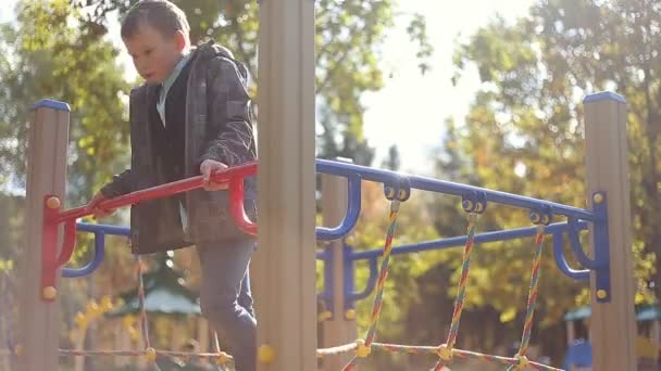 Boy playing on the playground — Stock Video