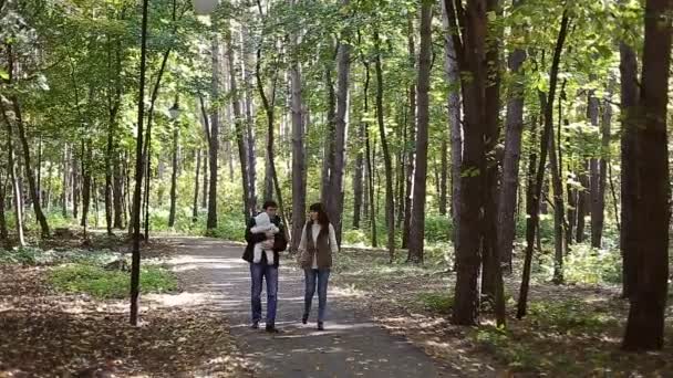 Család gyermekkel megy az őszi parkba — Stock videók