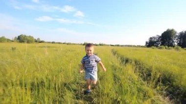 Boy running across hill in slowmotion