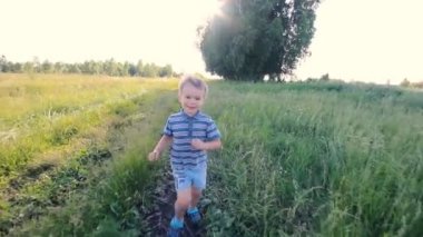 Boy running across hill in slowmotion