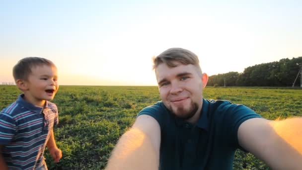 Happy smiling father and son take a self picture slowmotion — Stock Video