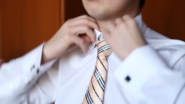 Close-up van de mens in shirt verkleden en stropdas op nek thuis aan te passen — Stockvideo