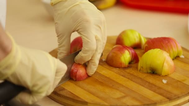hands cutting an apple
