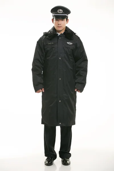 Δημιουργήστε όλων των ειδών τα ρούχα εργασίας αστυνομικός στέκεται μπροστά από ένα λευκό φόντο — Φωτογραφία Αρχείου