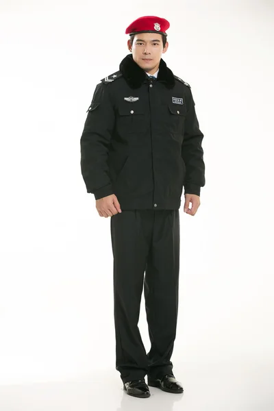 Create all kinds of work clothes policeman stands in front of a white background — Stock Photo, Image