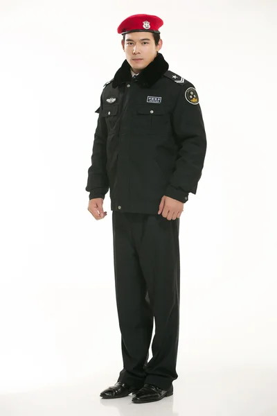 Create all kinds of work clothes policeman stands in front of a white background — Stock Photo, Image