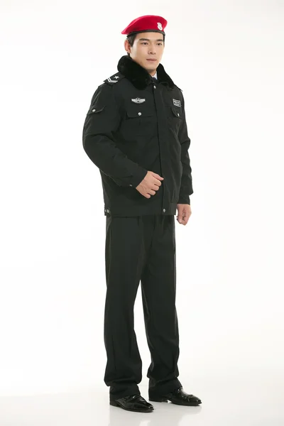 Create all kinds of work clothes policeman stands in front of a white background — Stock Photo, Image