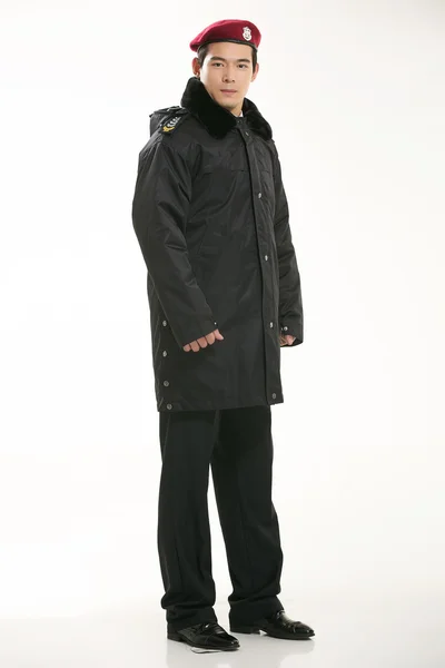 Create all kinds of work clothes policeman stands in front of a white background — Stock Photo, Image