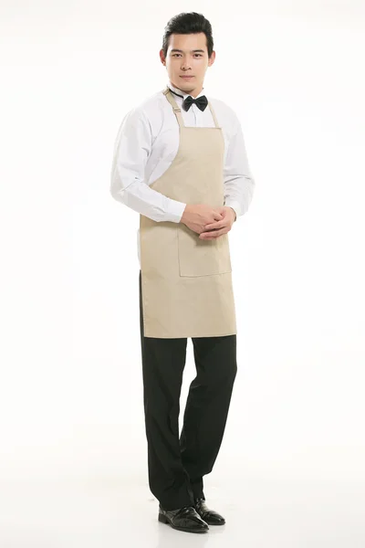 Nosić wszelkiego rodzaju fartuch kelner stojący w białym tle — Zdjęcie stockowe
