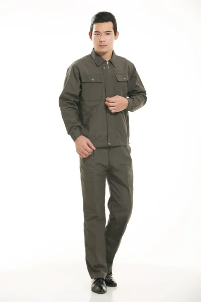 The young engineer various occupation clothing standing in front of a white background — Stock Photo, Image