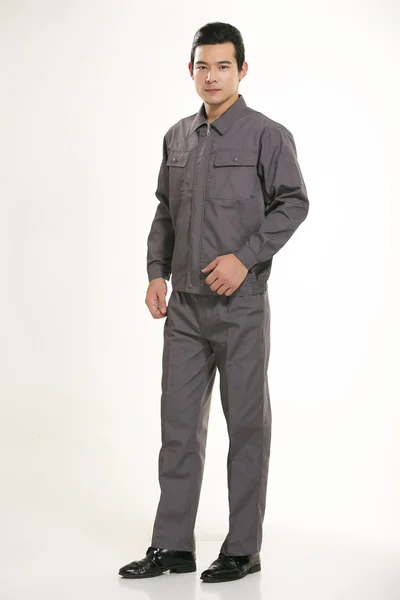 The young engineer various occupation clothing standing in front of a white background — Stock Photo, Image