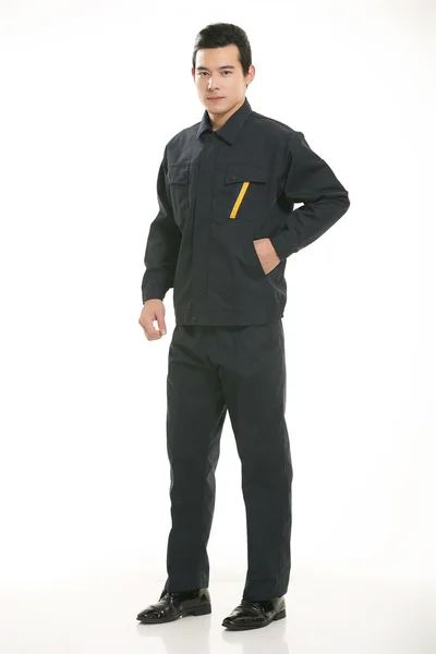 The young engineer various occupation clothing standing in front of a white background — Stock Photo, Image