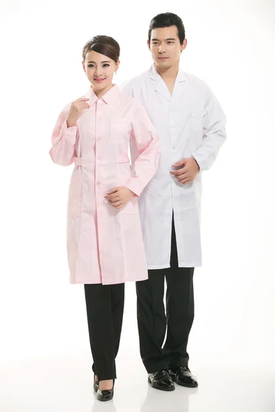 Staff wear coats in front of white background Stock Image