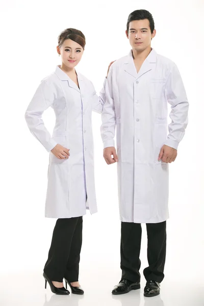 Staff wear coats in front of white background Stock Image