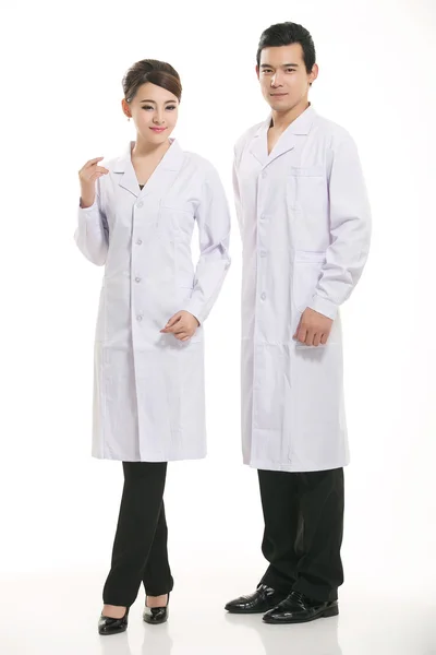 Staff wear coats in front of white background Stock Photo