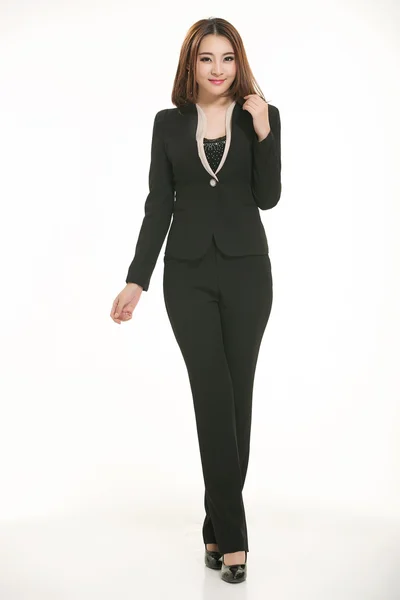 Young Asian women wearing a suit in front of a white background — Stock Photo, Image