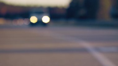 Arabalar otoyol boyunca hareket ediyor. Kentsel ortamda otomatik ışıklar.