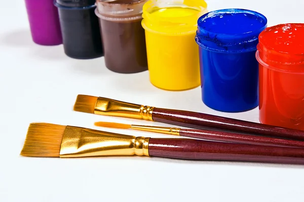 Bottles with gouache paints and brushes for artistic paintings. — Stock Photo, Image