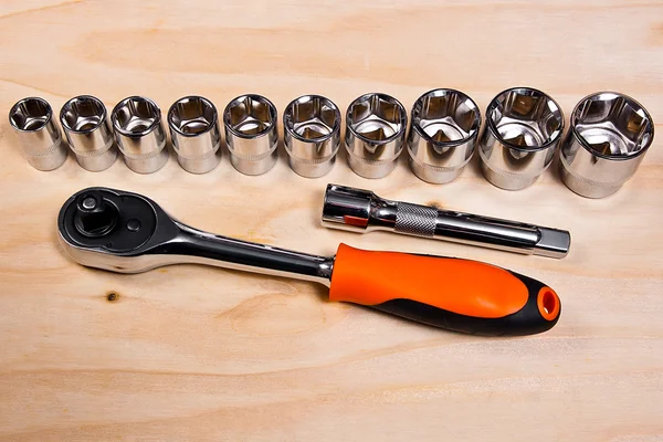 Metallic spanners on the wooden background — Stock Photo, Image