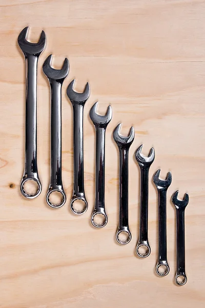 Metallic wrench on the wooden background — Stock Photo, Image