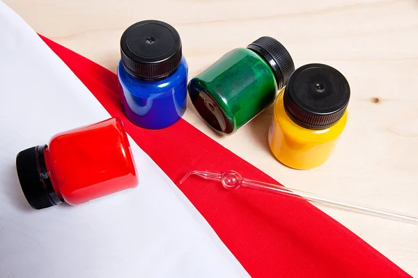 Batik equipment: artist paints and glass tube. — Stock Photo, Image