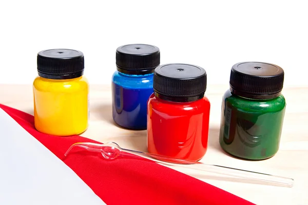 Batik equipment: artist paints and glass tube. — Stock Photo, Image