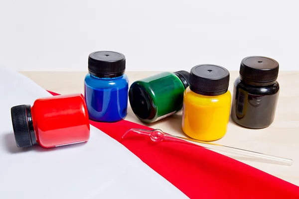 Equipment for cold batik: artist paints and glass tube. — Stock Photo, Image