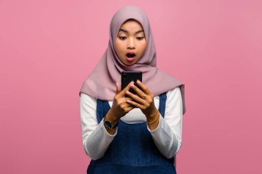 Genç Asyalı kadın cep telefonu kullanırken şok oldu.