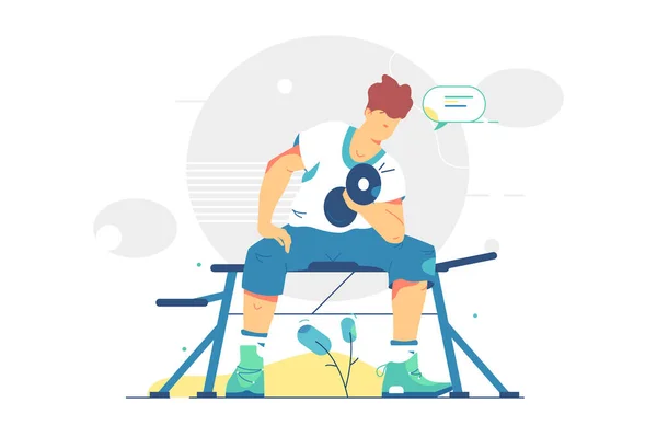 Genç adam ağır dambılları kaldırıyor.