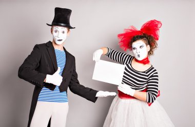 Two mimes with a sign for advertising clipart