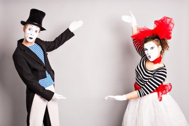 Your text here.  Colorful studio portrait of mimes with gray background. April fools day clipart