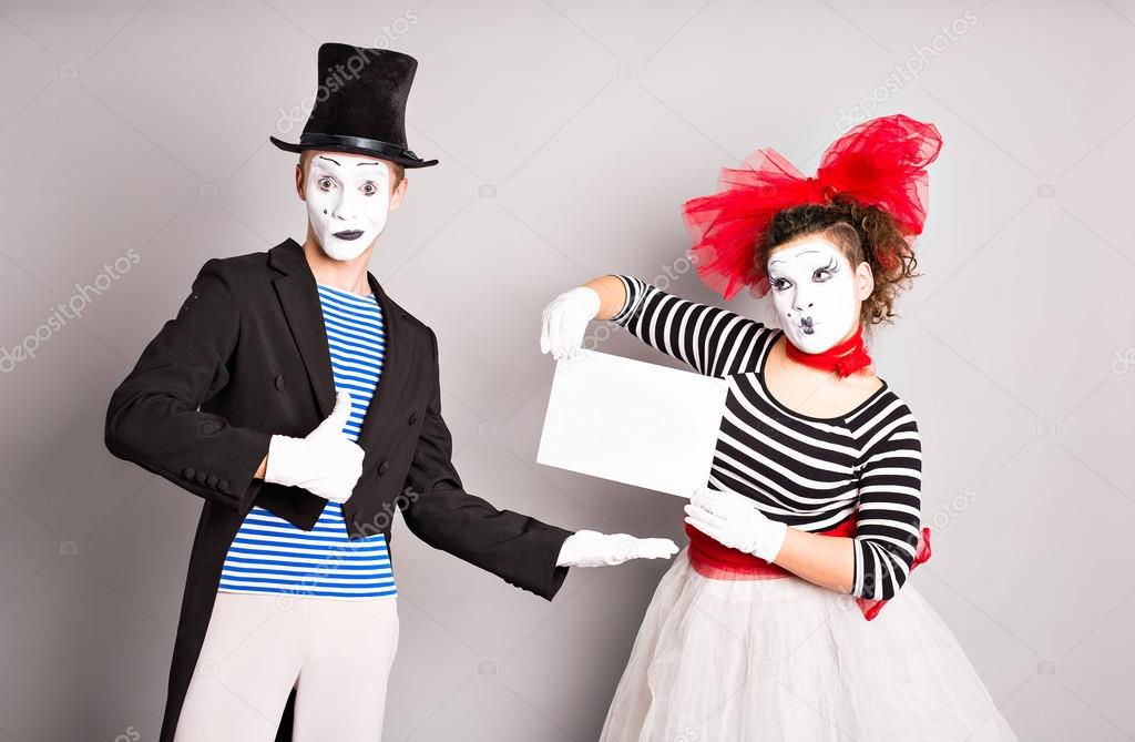 Two mimes with a sign for advertising