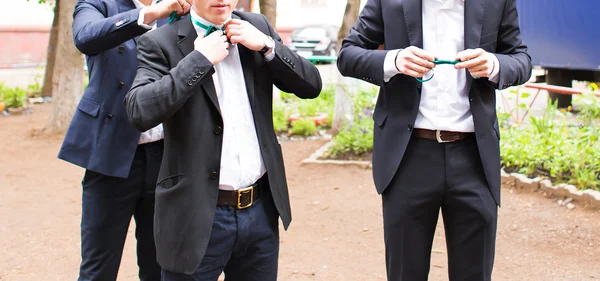 Group of young men with bow tie. Cheerful friends. Three friends outdoors. Wedding day. Three young friends happy.