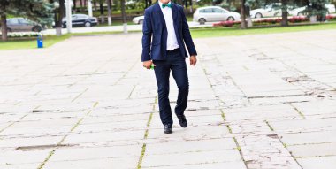 young handsome man walking in an urban context