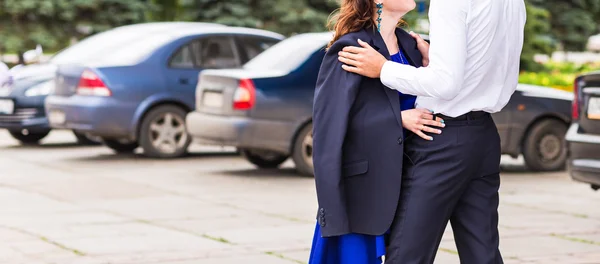 Happy young couple in love on the car parking — Zdjęcie stockowe