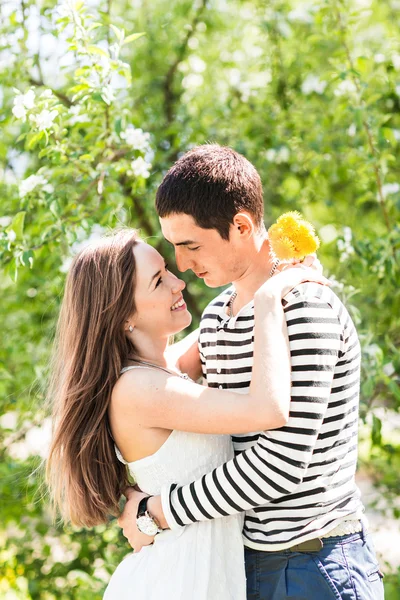 Romantiskt ungt par stående under Blossom Tree — Stockfoto