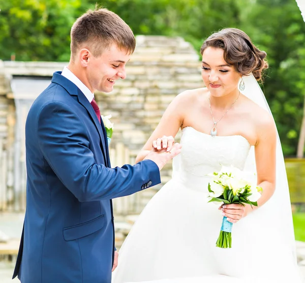 Vőlegény és menyasszony visel gyűrűt az ujján, esküvő. Arany, szimbólum, vallás, szerelem. — Stock Fotó