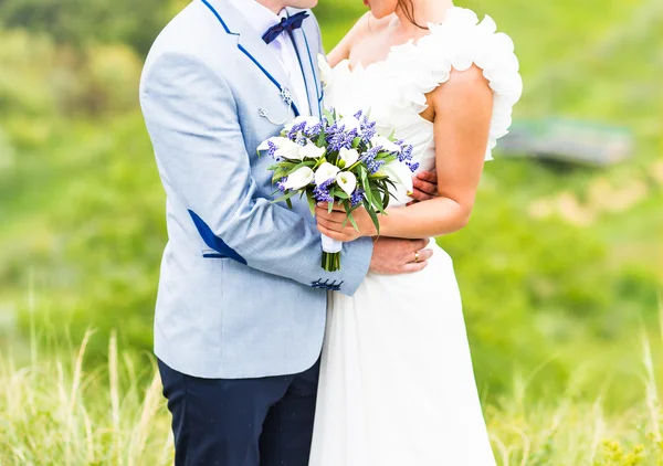 Braut und Bräutigam mit Brautstrauß — Stockfoto