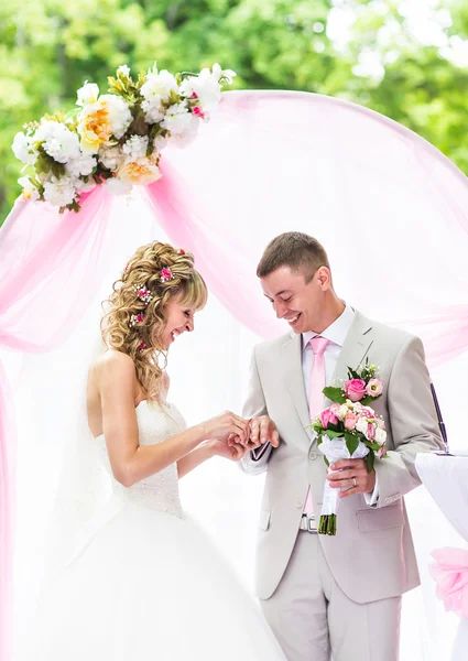 Sposa mettendo un anello al dito sposi durante la cerimonia nuziale — Foto Stock