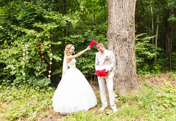 Retrato de casal recém-casado feliz lutando com letras decorativas — Fotografia de Stock