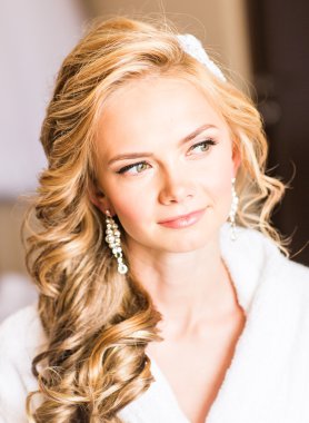 Güzel genç gelin düğün makyaj ve saç yatak ile çekici yeni evli kadın var düğün için son hazırlık ve sunuş.