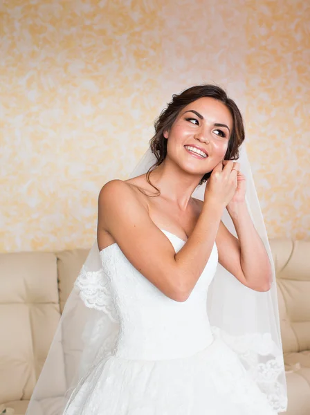 Elegante bruid zetten oorbellen, bruiloft voorbereiden — Stockfoto