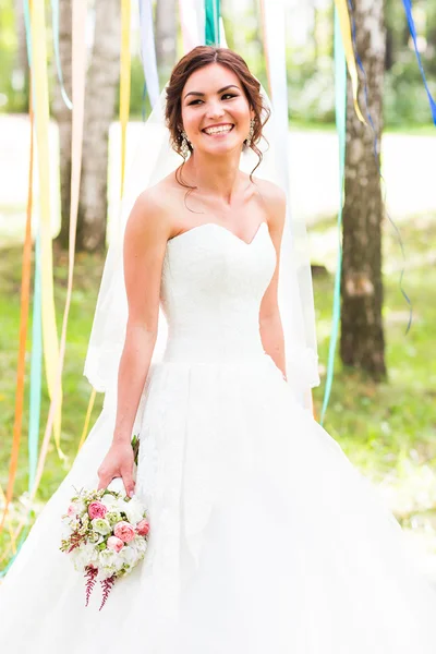 Beautiful bride outdoors in a forest. — Stock Photo, Image