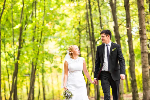 Gelin ve damat dışarıda el ele tutuşuyorlar. — Stok fotoğraf