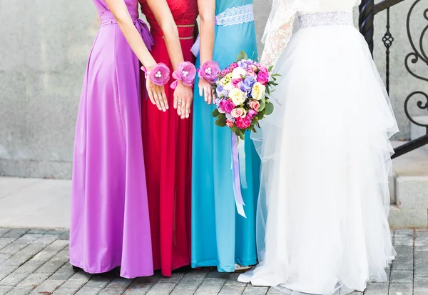 Bride with bridesmaids outdoors on the wedding day